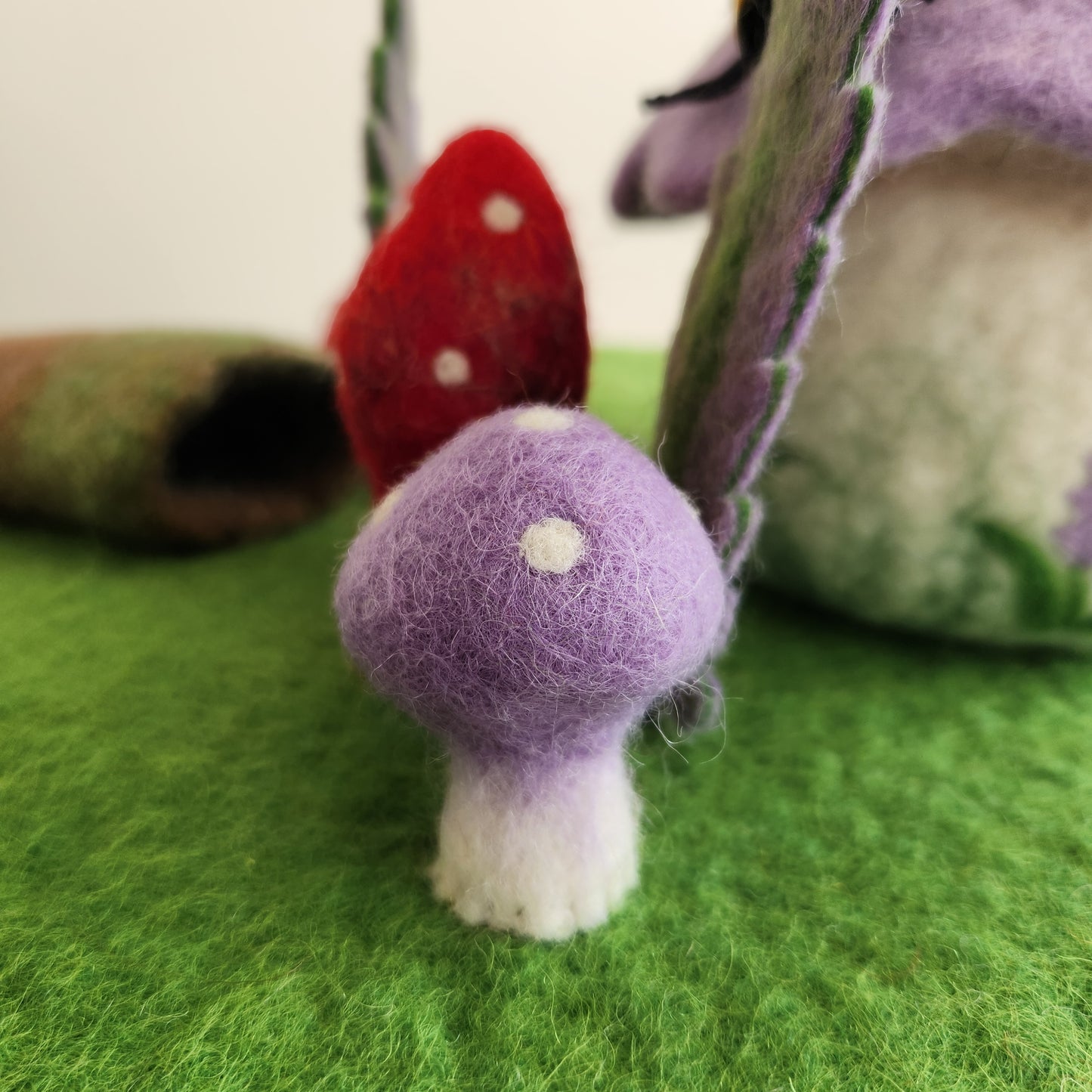 FOREST FLOOR STORYTELLING PLAYMAT - GREEN FELT PLAYMAT WITH ATTACHED MUSHROOMS, FERNS AND A HOLLOW LOG.