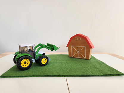 Felted Paddock Playmat with toy tractor and wooden barn