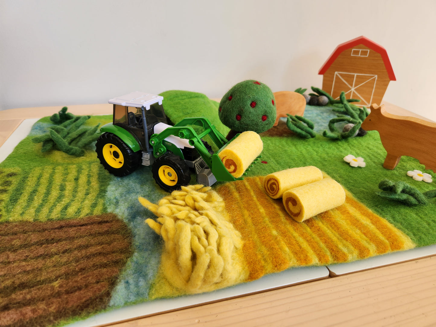 Happy Hooves - Felt Farmyard Play Mat with green toy tractor and wooden farm toys