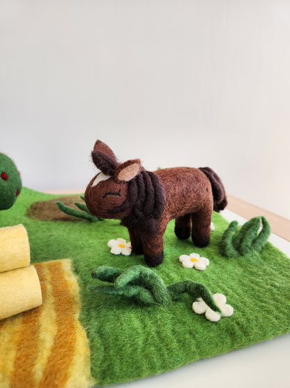 Felt Farmyard Play Mat and felted toy horse standing in grass daisy field