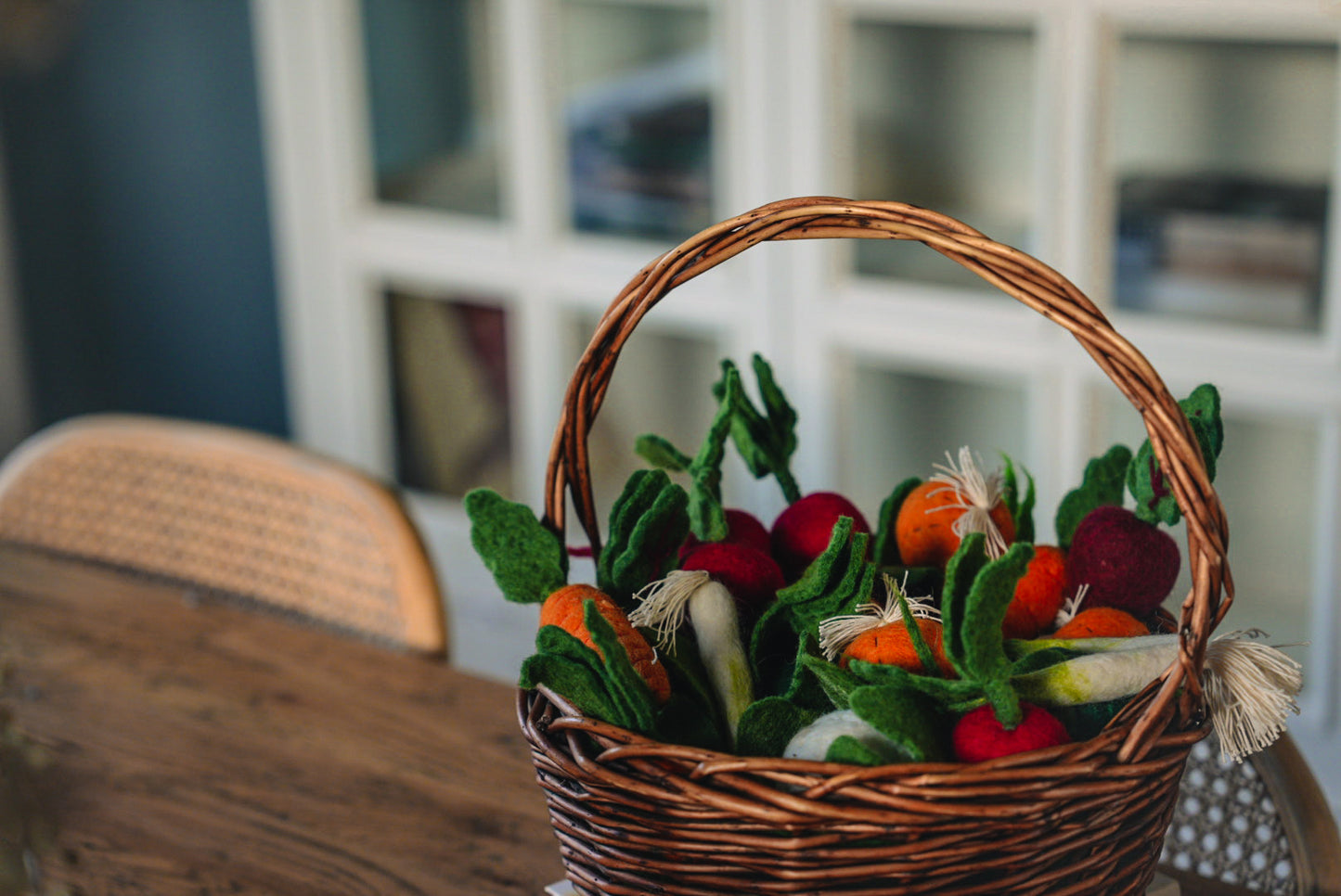 WHOLESOME HARVEST PLAY FELT GARDEN TOY SET GARDEN VEGETABLES IN BASKET ON KITCHEN TABLE