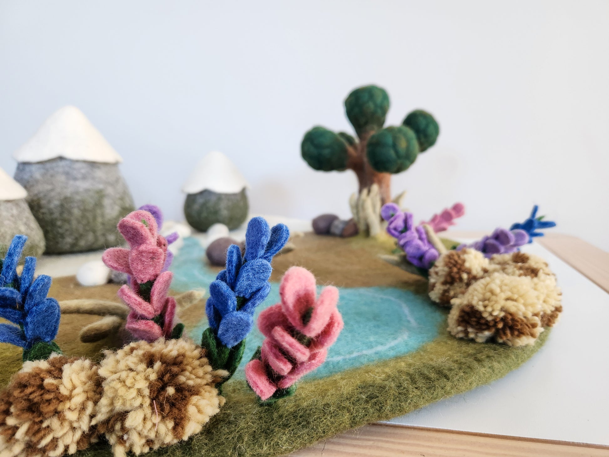 Felted landscape with colourful flowers