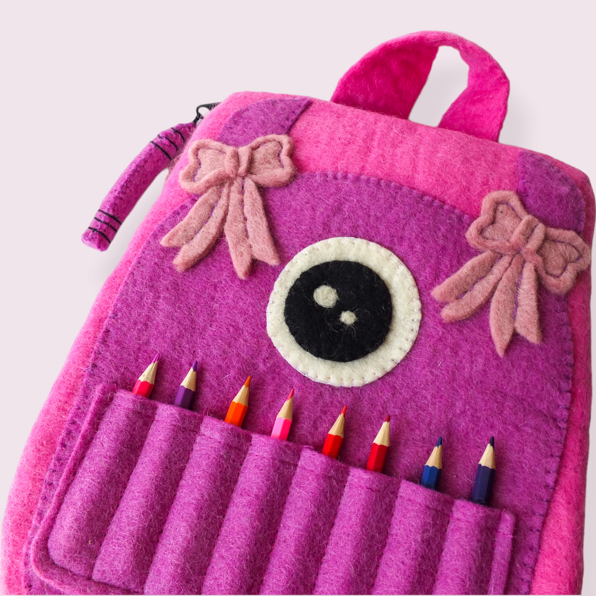 CUTE MONSTER FELTED CRAFT BAG PINK AND PURPLE CLOSE UP VIEW WITH PENCILS