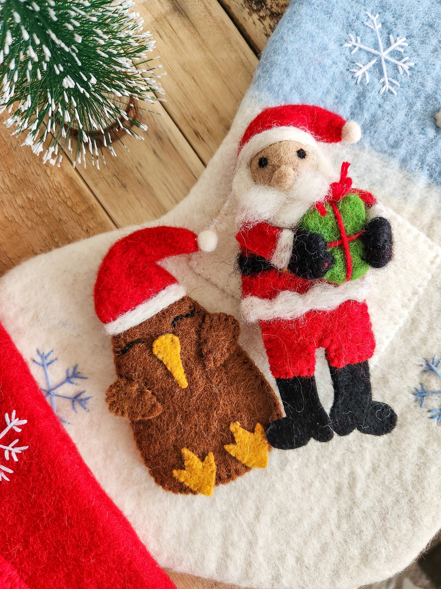 Christmas Kiwi and Classic Santa Finger Puppets on Winter Wonderland Felted Christmas Stocking