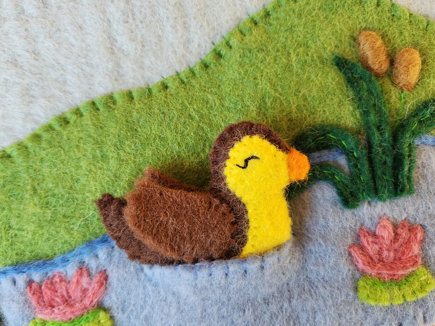 FIVE LITTLE DUCKS FELT FINGER PUPPET SET - CLOSE UP VIEW OF DUCK IN STORAGE POUCH POCKET