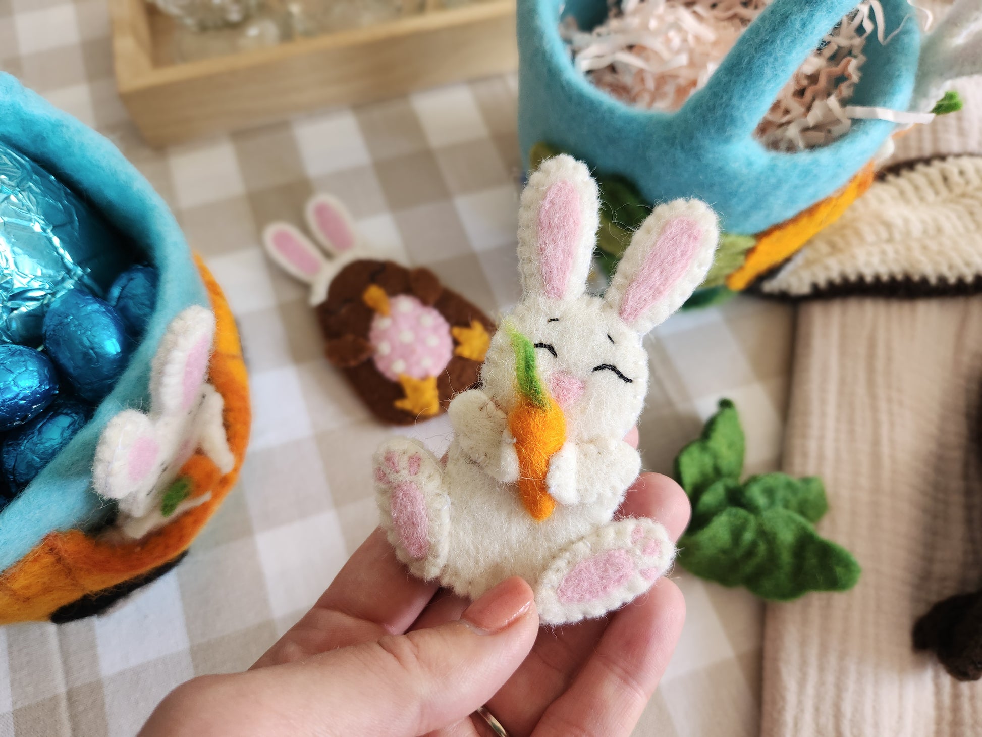 Felt Bunny Finger Puppet holding carrot with Carrot Car Easter Baskets in background