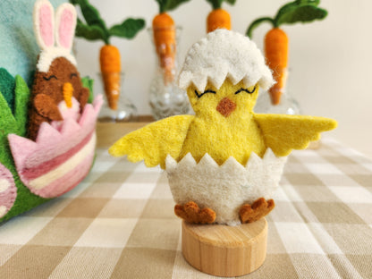 Felt Easter Chick Finger Puppet on Puppet Stand with easter decorations in the background