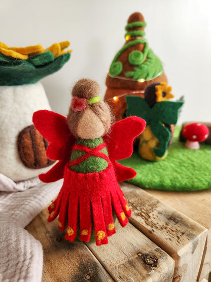 Felt Pohutukawa Fairy Toy - Red and green Christmas Fairy with felt fairy houses in background