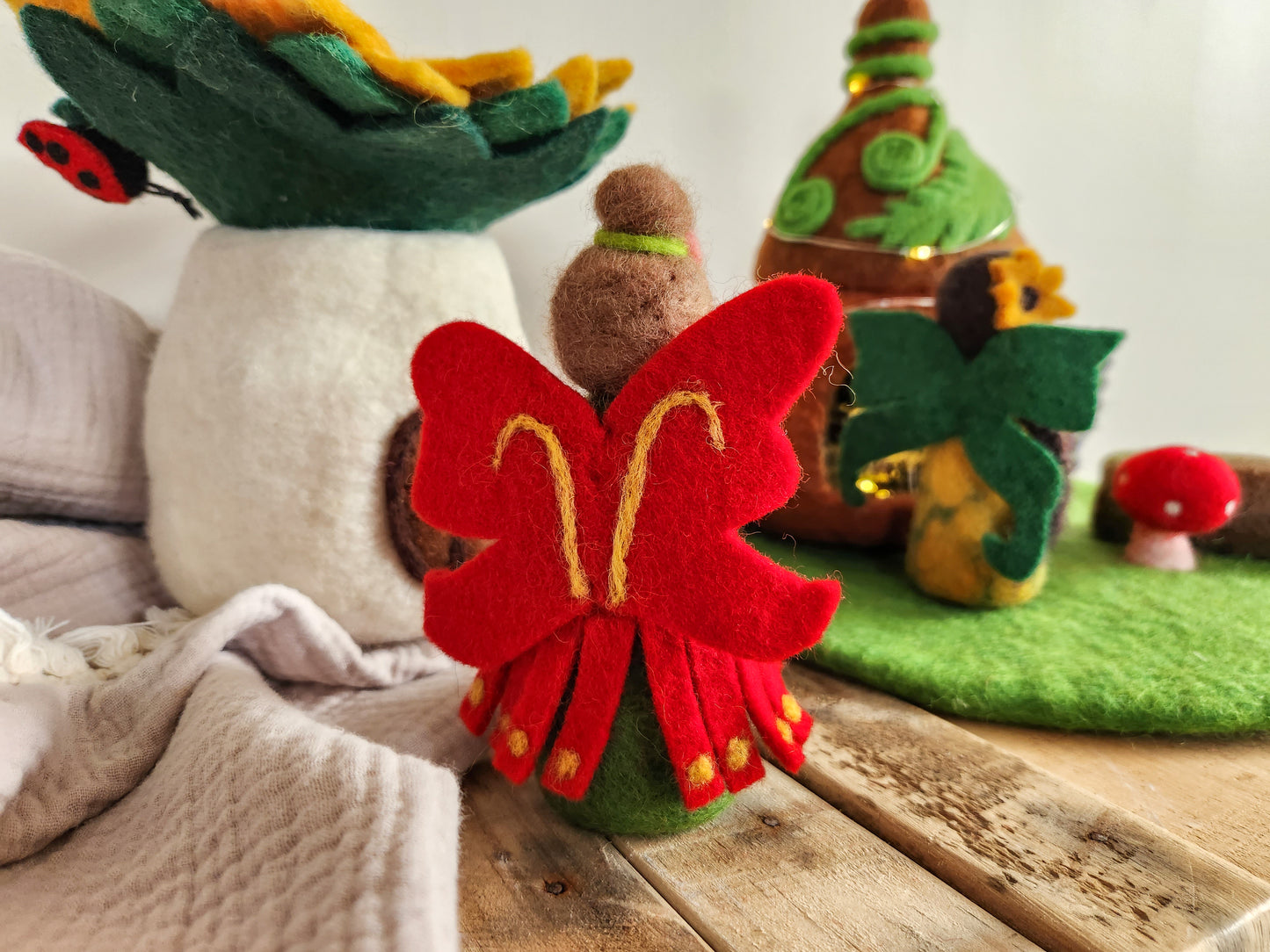 Felt Pohutukawa Fairy - Red and green Christmas Fairy with felt fairy houses in background