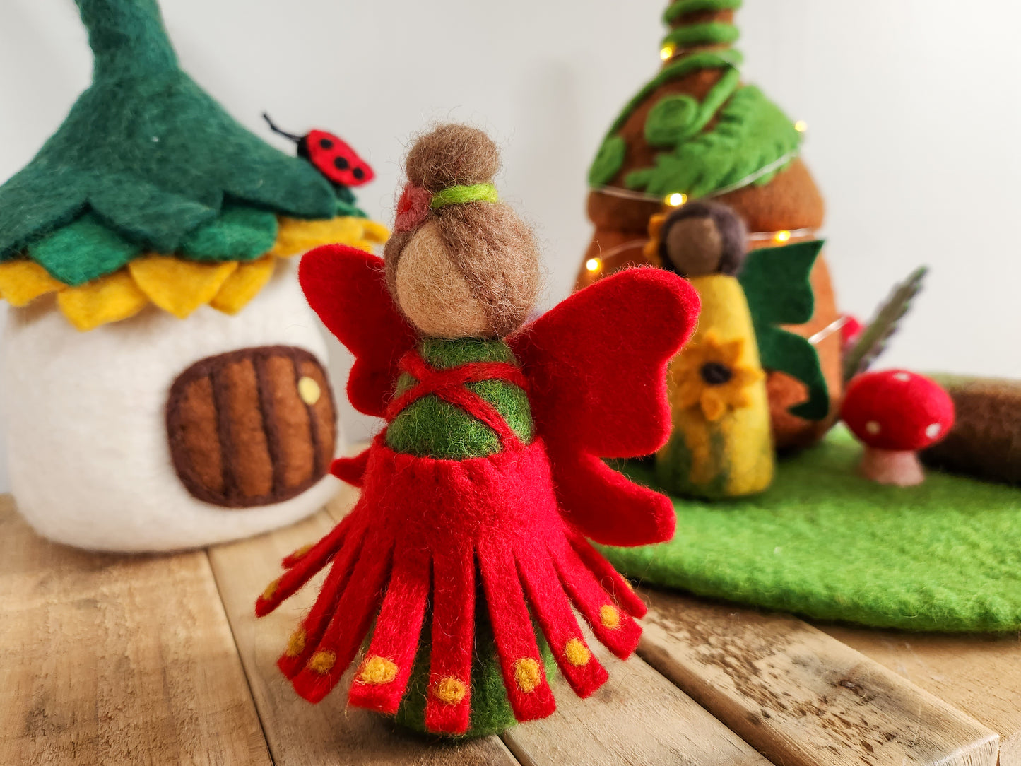 Felt Pohutukawa Fairy - Red and green Christmas Fairy with felt fairy houses in background