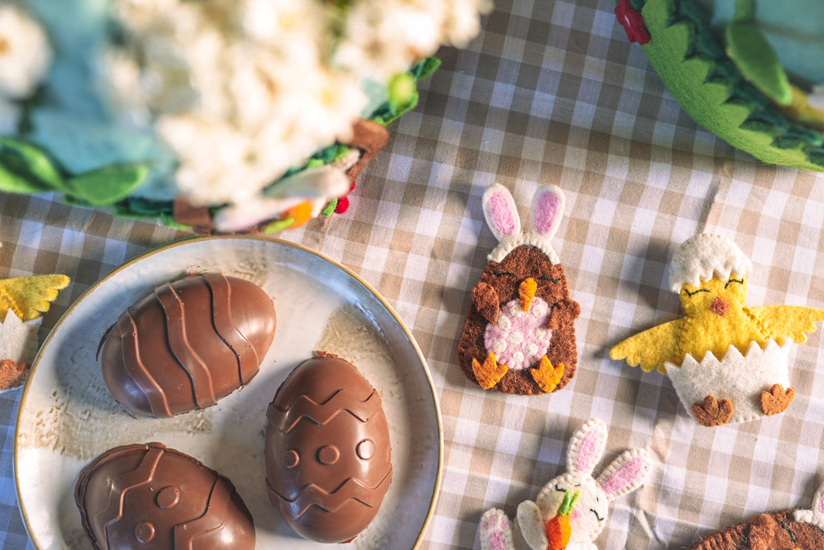 Felt easter finger puppets with chocolate eggs on table