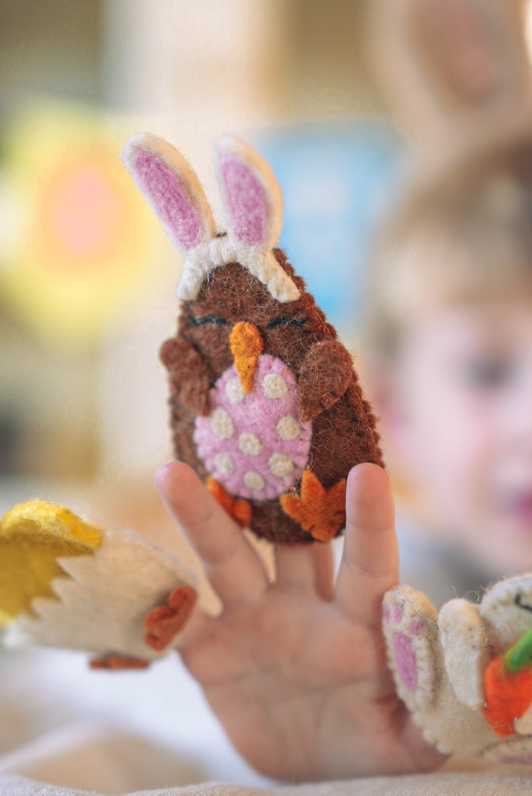 Young Boy playing with Felted Easter Kiwi Finger Puppet 