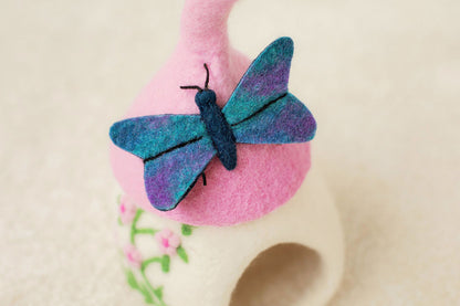 WHITE AND PINK FELT FAIRY HOUSE WITH PINK FLOWER DETAILS AND BLUE BUTTERFLY