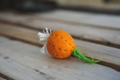 Felt onion play toy on wooden bench